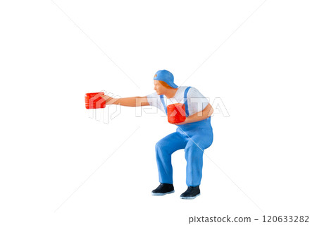 A miniature figurine of a painter  holding a paint can and brush isolate on white background with clipping path 120633282