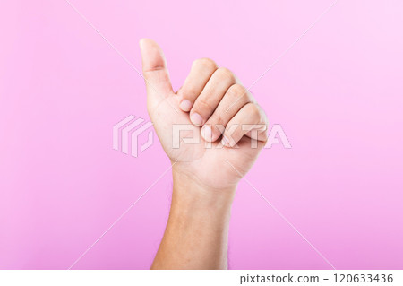 A hand displays various gestures, including a fist, open palm, and raised fingers, against a pink background. A visual exploration of communication through hand symbols A hand displays various gestures, including a fist, open palm, and raised fingers, against a pink background. A visual exploration of communication through hand symbols 120633436