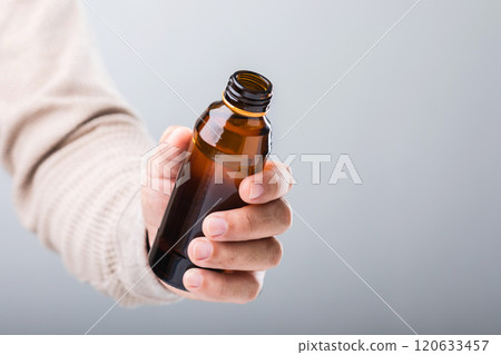 A man holds a bottle energy drink, prompting the question of its health impact-whether it boosts energy or has potential downsides. A reflection on making mindful choices for well-being 120633457