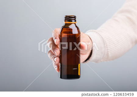 A man holds a bottle energy drink, prompting the question of its health impact-whether it boosts energy or has potential downsides. A reflection on making mindful choices for well-being 120633459