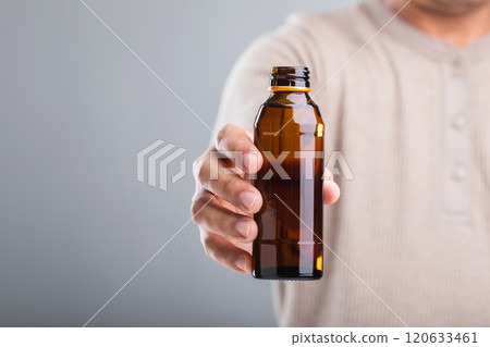 A man holds a bottle energy drink, prompting the question of its health impact-whether it boosts energy or has potential downsides. A reflection on making mindful choices for well-being A man holds a bottle energy drink, prompting the question of its health impact-whether it boosts energy or has potential downsides. A reflection on making mindful choices for well-being 120633461