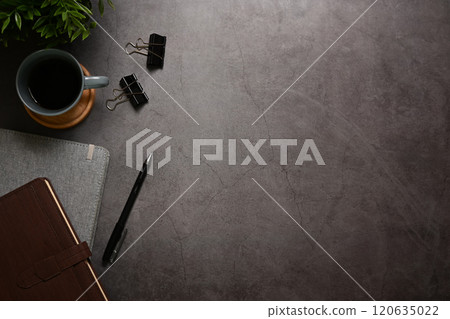 Stylish office desk with cup of coffee and leather journal with a pen. Space for text Stylish office desk with cup of coffee and leather journal with a pen. Space for text 120635022
