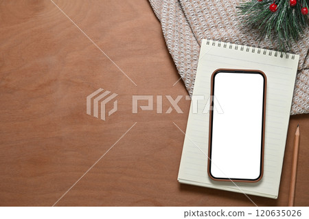 Top view smartphone, notebook and pine branches on wooden table Top view smartphone, notebook and pine branches on wooden table 120635026