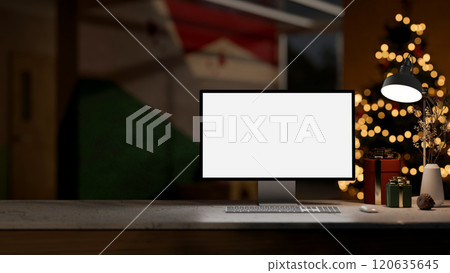 A computer, gift boxes and a table lamp on a tabletop in a dark room on the Christmas night. A computer, gift boxes and a table lamp on a tabletop in a dark room on the Christmas night. 120635645