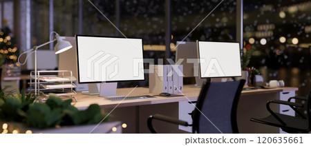 A modern office inside a skyscraper on a Christmas winter night features sleek computer desks. 120635661