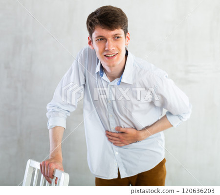 Man experiencing acute abdominal pain 120636203