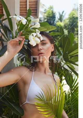 beautiful summer girl. young sexy woman in bikini under palm tree and flowers beautiful summer girl. young sexy woman in bikini under palm tree and flowers 120636606
