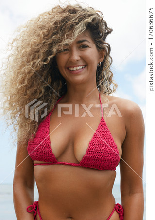 Beautiful happy woman on the beach. Smiling girl in Bikini near sea Beautiful happy woman on the beach. Smiling girl in Bikini near sea 120636675