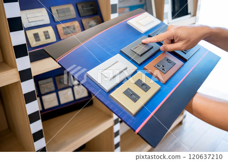 Choosing light switch and electric socket on product sample display board 120637210