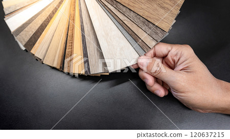 Designer hand picking sample of wood laminated material Designer hand picking sample of wood laminated material 120637215