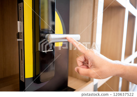 Customer hand pointing at door handle of smart digital door lock 120637522