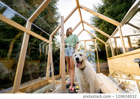 Female Carpenter with Her Dog in Greenhouse Female Carpenter with Her Dog in Greenhouse 120638032