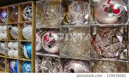Christmas decorations, various balls in boxes on shop windows. 120638082