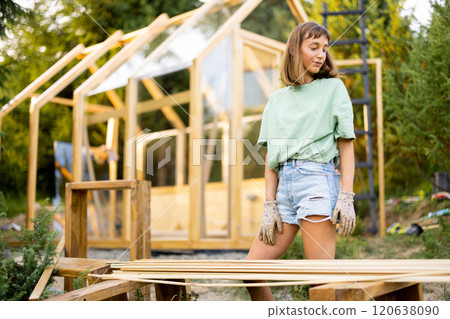 Female Carpenter in Backyard 120638090