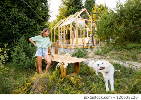 Woman building greenhouse at backyard 120638120