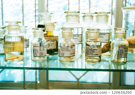 flasks and test tubes with samples on shelf of a secret biochemical laboratory flasks and test tubes with samples on shelf of a secret biochemical laboratory 120638260