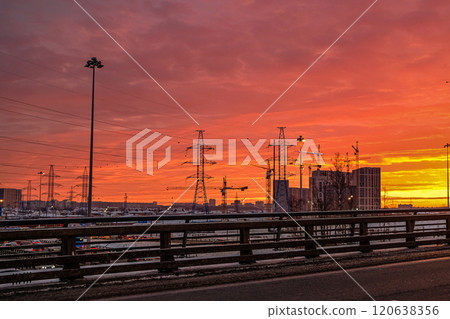 Construction cranes and silhouette of buildings under construction against the colorful dawn sky 120638356