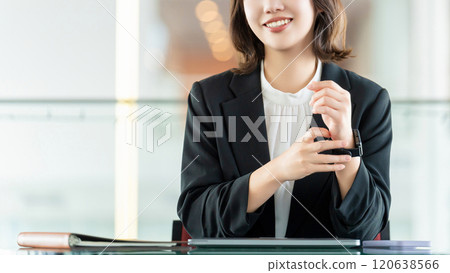 Smiling woman/businesswoman doing desk work Smiling woman/businesswoman doing desk work 120638566