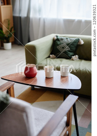 Vertical background image of cozy minimal living room with comfortable couches and hot drinks on coffee table copy space 120639321