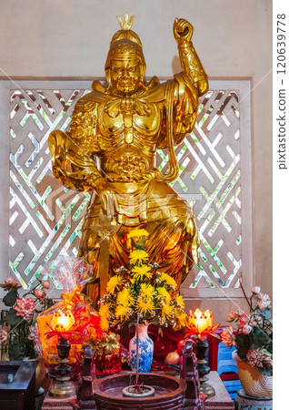 Golden statue of a warrior inside a temple on Buddhist pagoda in Vietnam in Asia 120639778