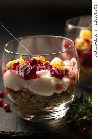 Two glasses of dessert with berries and nuts 120639801