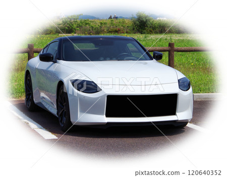 An image of a person going for a drive in a white sports car on a sunny day off, taking a break in a parking lot in a park and admiring the scenery. 120640352