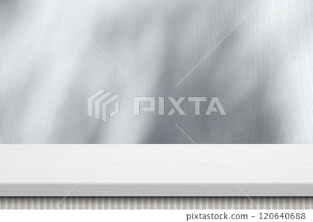 White Table in Japandi Style and Wall Background with Leaves Shadow and Light Beam to the Surface White Table in Japandi Style and Wall Background with Leaves Shadow and Light Beam to the Surface 120640688