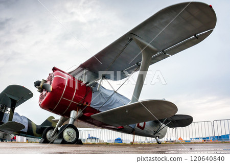 Retro biplanes in the parking lot under a little rain 120640840