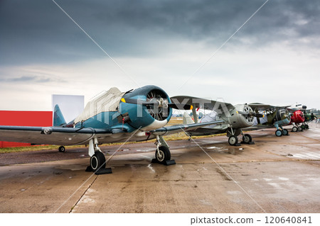 Retro airplanes in the parking lot on a cloudy day Retro airplanes in the parking lot on a cloudy day 120640841