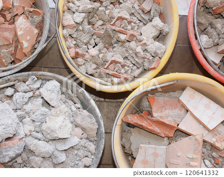bucket full of demolition rubble 120641332
