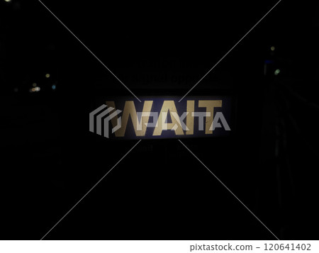Wait sign at pedestrian crossing at night in London Wait sign at pedestrian crossing at night in London 120641402