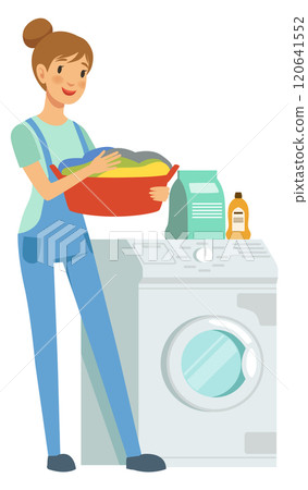 A woman is standing in front of a washing machine and dryer 120641552