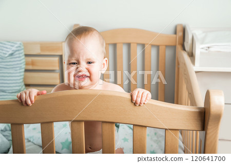 Curious Baby Standing in a Wooden Crib Curious Baby Standing in a Wooden Crib 120641700