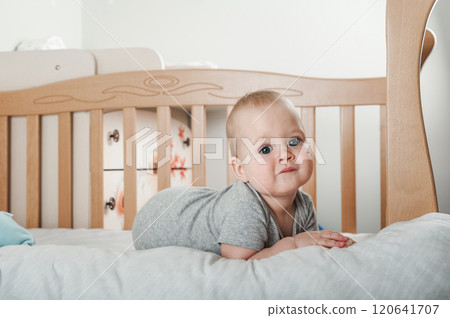 Curious Baby Standing in a Wooden Crib Curious Baby Standing in a Wooden Crib 120641707