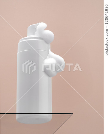 Bottle of gentle foam facial cleanser on pink Bottle of gentle foam facial cleanser on pink 120641956