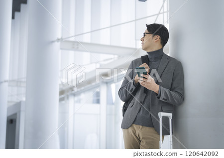 A man in his 40s holding a smartphone A man in his 40s holding a smartphone 120642092