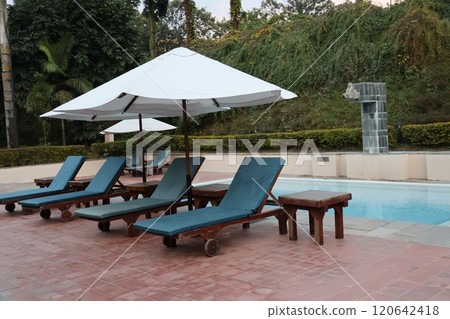 Scenery of a resort hotel pool with poolside beds and parasols in Kathmandu, Nepal 120642418