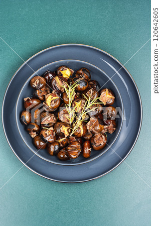 Warm roasted chestnuts served on a plate Warm roasted chestnuts served on a plate 120642605
