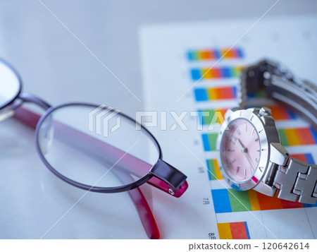Graph, glasses and watch on a table 120642614