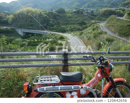 Bike riding through the mountains 120642656