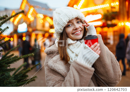 Woman enjoying winter moments. Festive Christmas fair, winter holidays concept. Woman enjoying winter moments. Festive Christmas fair, winter holidays concept. 120642703