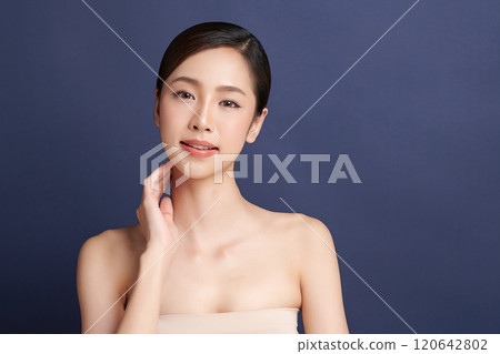 Beautiful young asian woman with clean fresh skin on blue background, Face care, Facial treatment, Cosmetology, beauty and spa, Asian women portrait. Beautiful young asian woman with clean fresh skin on blue background, Face care, Facial treatment, Cosmetology, beauty and spa, Asian women portrait. 120642802