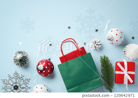 Christmas gift box in green bag with christmas decorations on blue background Christmas gift box in green bag with christmas decorations on blue background 120642971