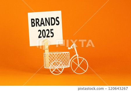 Planning brands 2025 new year symbol. Concept words Brands 2025 on beautiful white paper on wooden clothespin. Beautiful orange background. Bicycle. Business brands 2025 new year concept. Copy space. 120643267