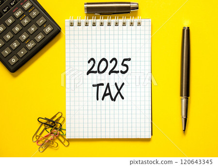 Planning 2025 tax new year symbol. Concept words 2025 Tax on beautiful white note. Beautiful yellow paper background. Black calculator. Business 2025 tax new year concept. Copy space. 120643345