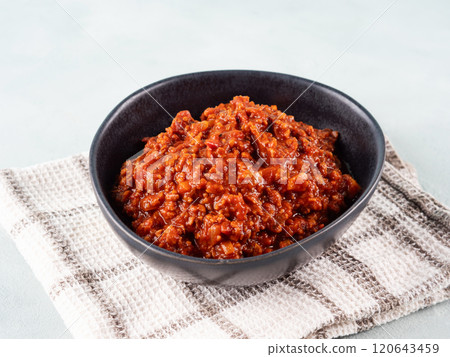 Vegan bolognese ragu with soya protein granules on turquoise background 120643459