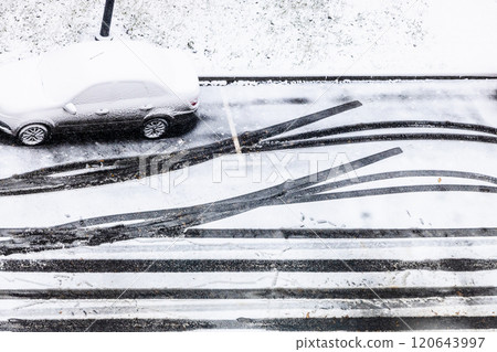 above view of car tracks on snow covered road 120643997