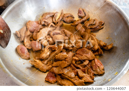 cut into pieces turkey fillet is fried in wok 120644007