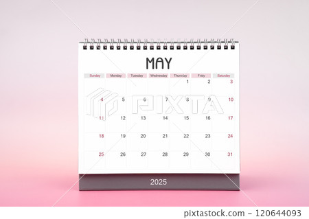 Desktop monthly calendar for May 2025 on pink background. 120644093