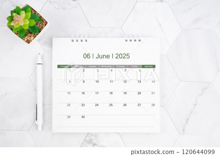 Desk calendar on month of June 2025 with pen on white marble background. 120644099